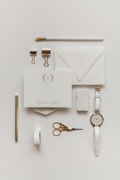 Elegant personalized stationery with gold monogram wreath, minimal calligraphy, and cream envelope styling