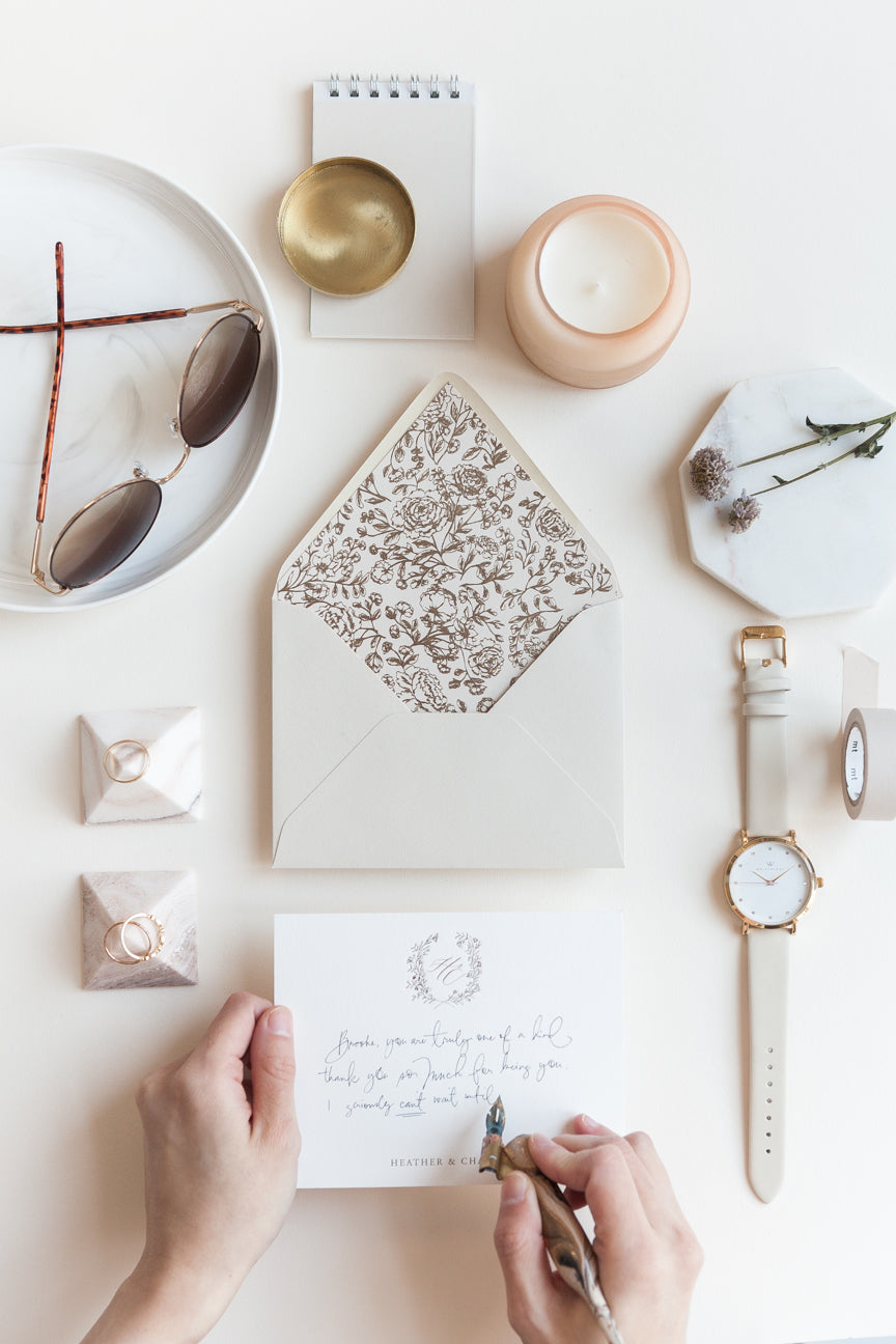 Custom stationery with floral liner envelope styled with watch, sunglasses and neutral accessories