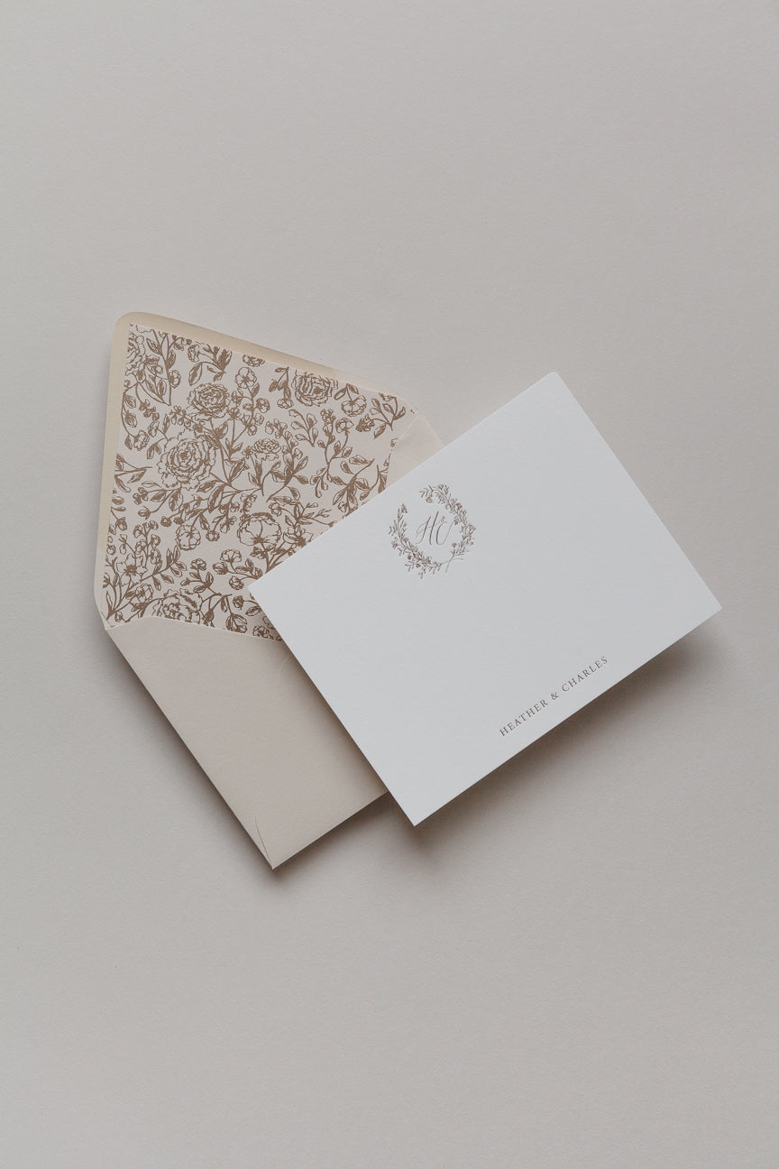 Personalized stationery card with gold foil monogram and floral liner envelope in soft neutral palette