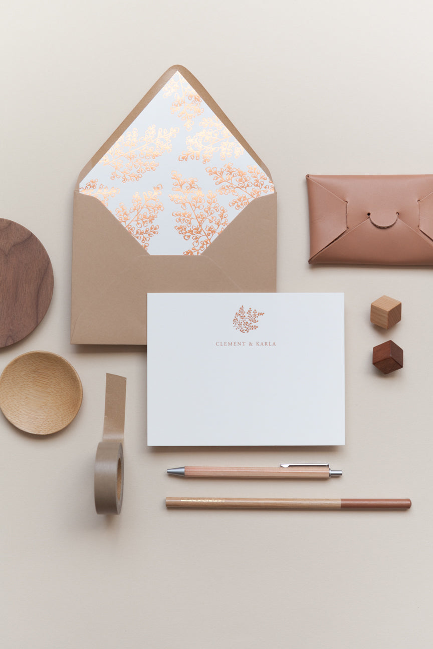 Personalized stationery with kraft envelope, floral liner, pen, and minimal neutral flat lay