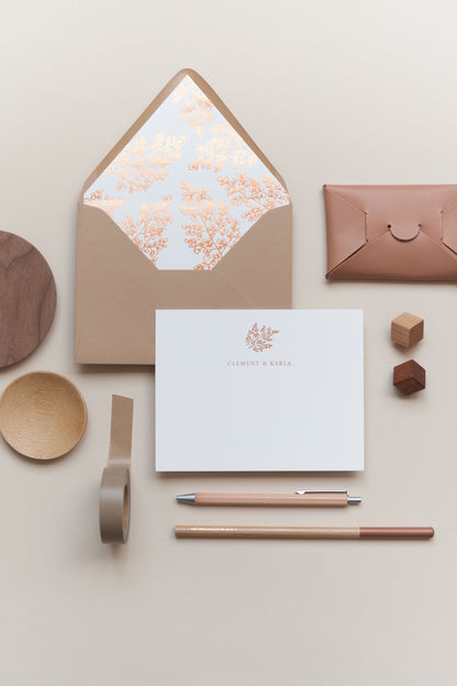 Personalized stationery with kraft envelope, floral liner, pen, and minimal neutral flat lay
