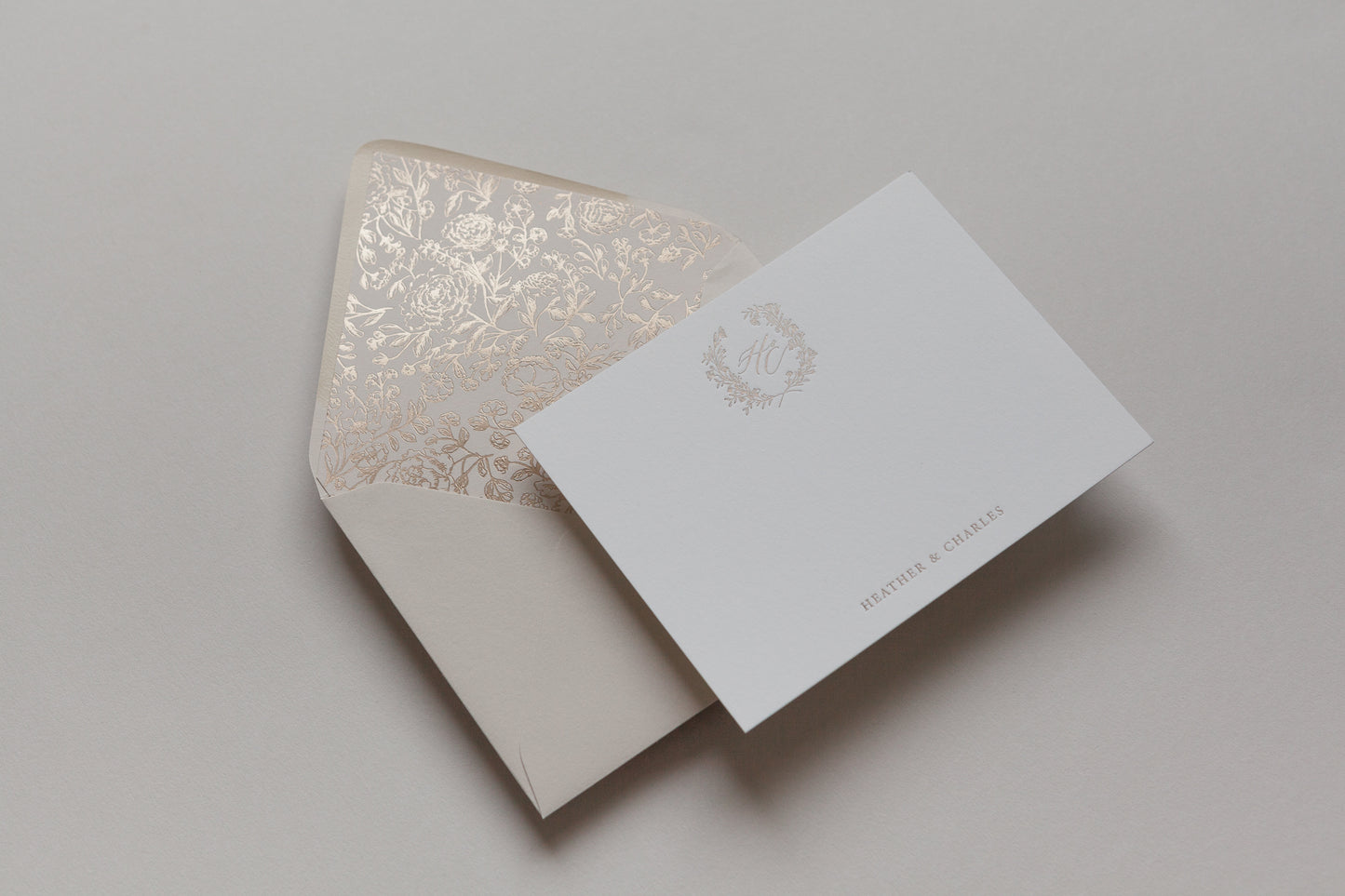 Custom stationery with gold foil monogram and floral envelope liner in elegant neutral tones