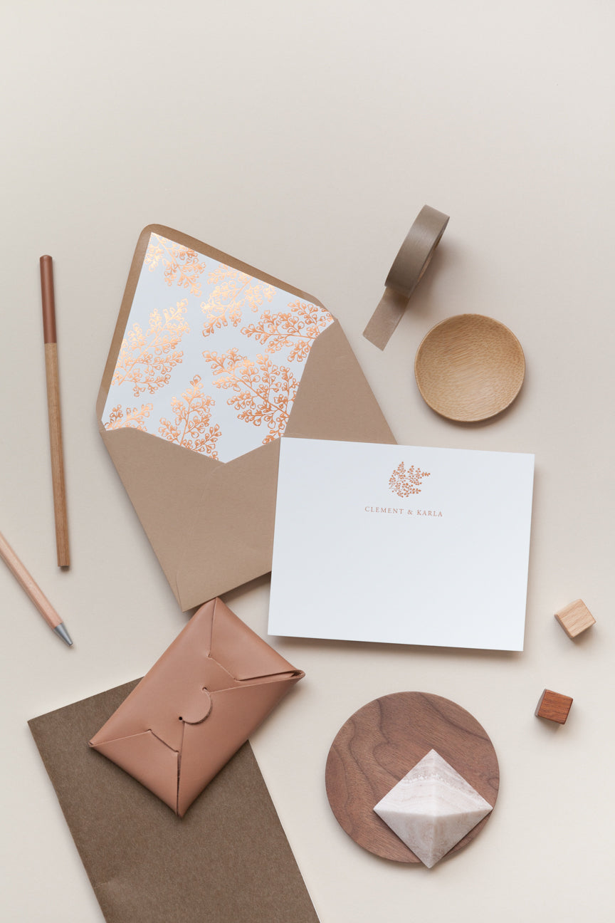 Wedding stationery set with floral liner envelope, card, pen, and neutral styling elements