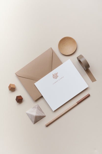Personalized stationery flat lay with kraft envelope, card, pencil, and neutral-toned desk accessories