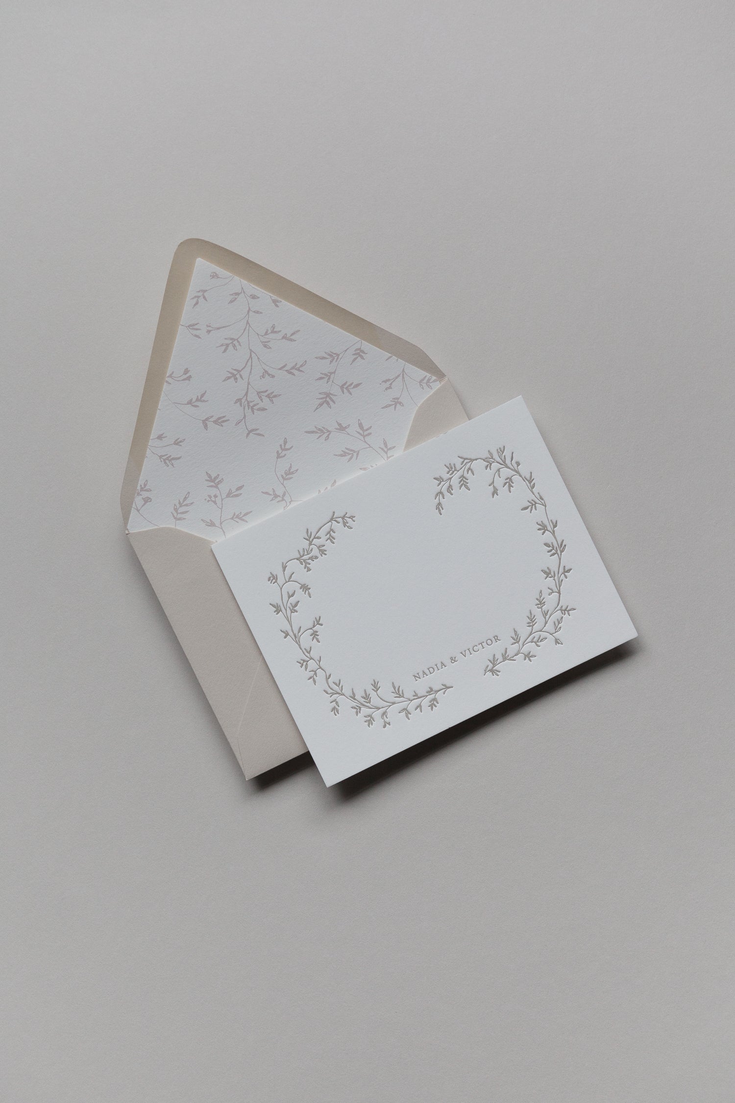 Custom wedding stationery card with floral wreath and envelope, personalized letterpress design
