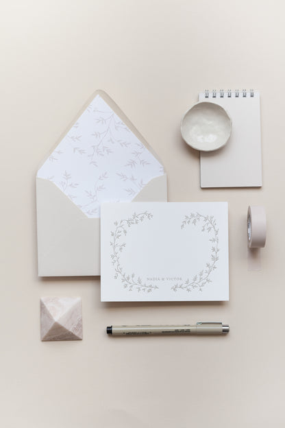 Personalized wedding stationery with floral card and envelope liner in soft neutral tones